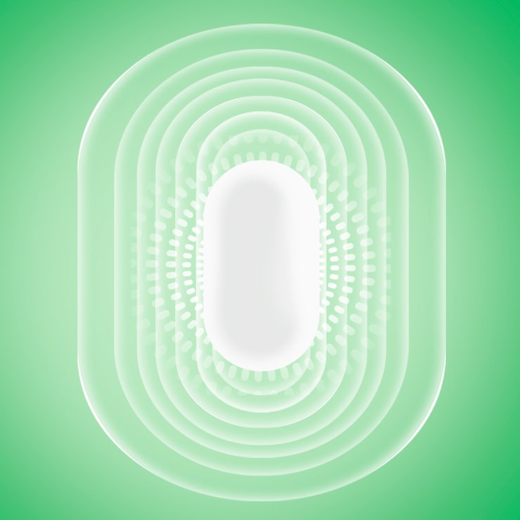 Une pastille de Tic Tac blanche avec un effet de rayonnement sur un fond vert 