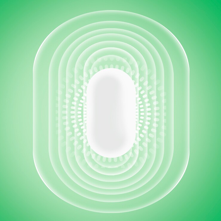 Une pastille de Tic Tac blanche avec un effet de rayonnement sur un fond vert 