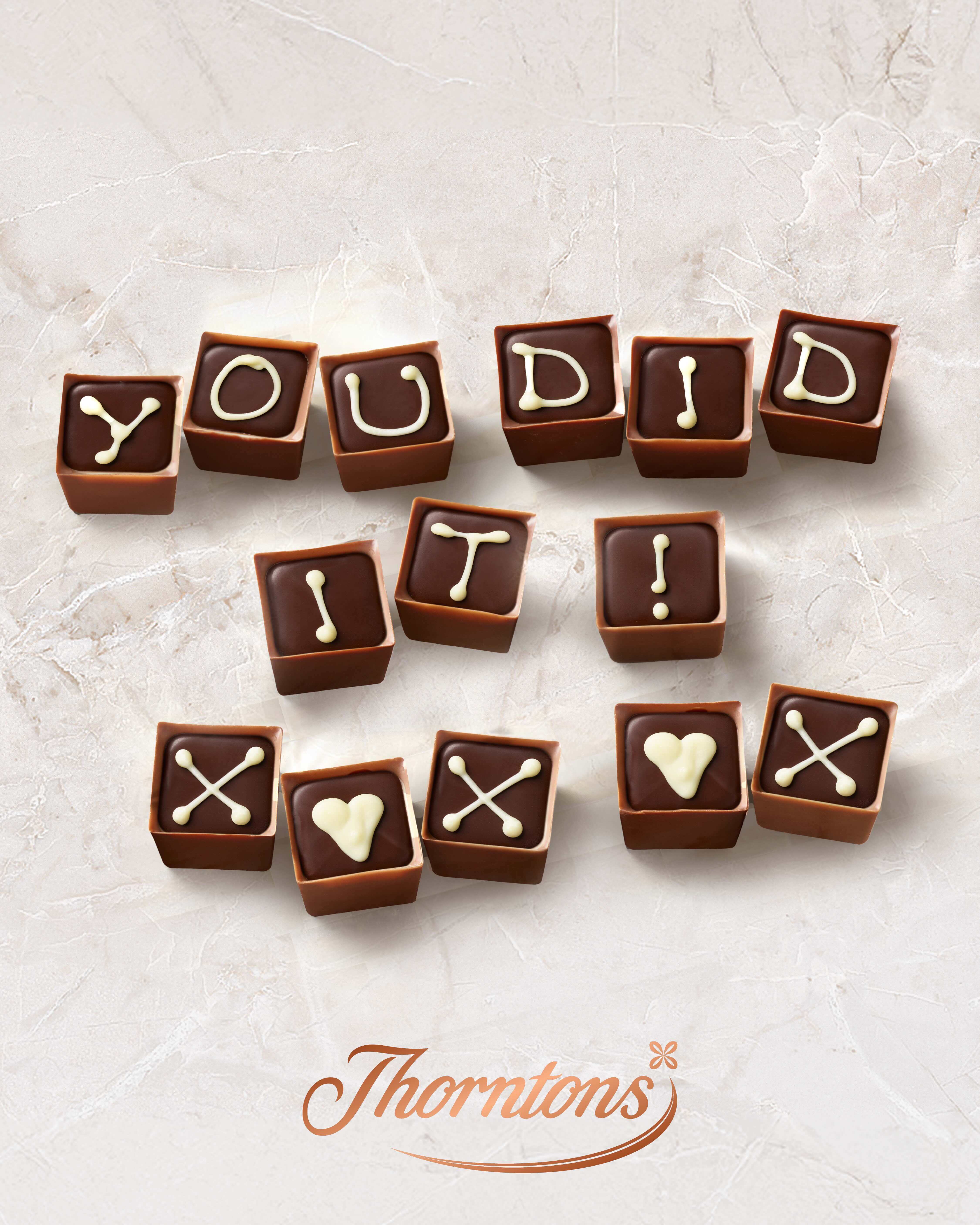 Lots of square milk chocolates spelling out 'you did it !'